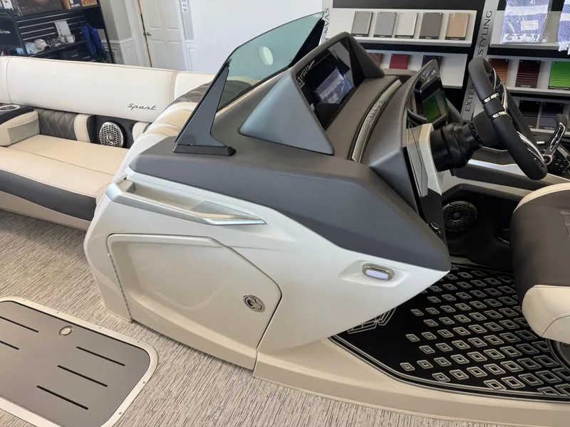 Slide: The Image of 2025 Bennington 25QFBA boat interior with modern helm and luxurious seating. - 25