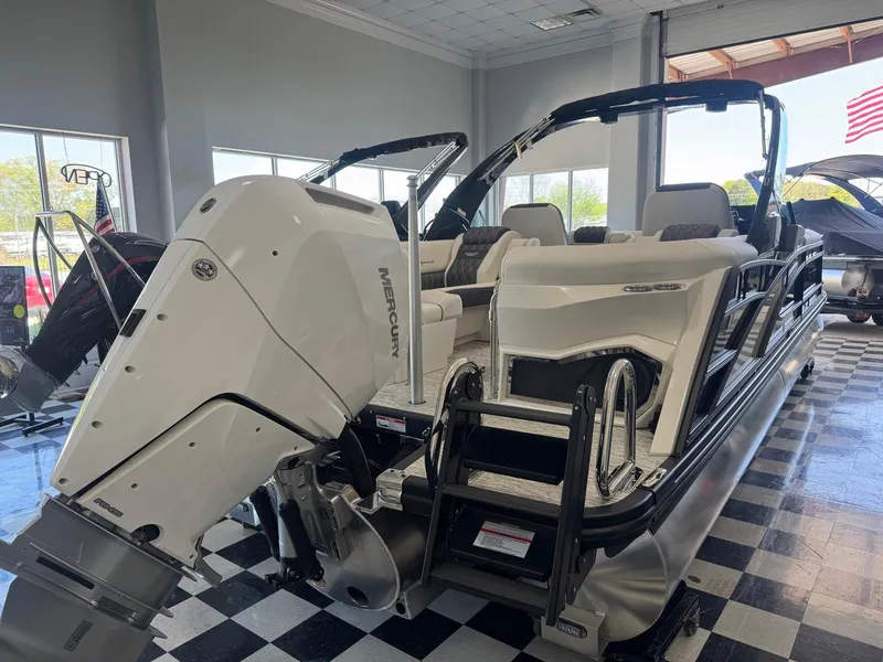 Slide: The Image of 2025 Bennington 25QFBA pontoon boat with Mercury engine in showroom. - 5