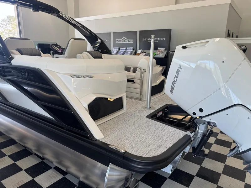 Slide: The Image of 2025 Bennington 25QFBA pontoon boat with Mercury engine in showroom. - 6