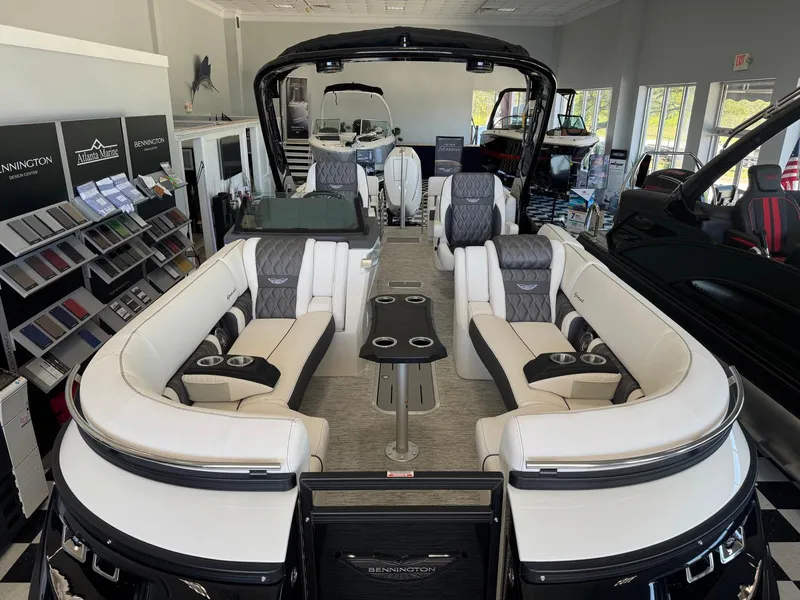 Slide: The Image of 2025 Bennington 25QFBA pontoon boat interior with luxurious seating in showroom. - 8
