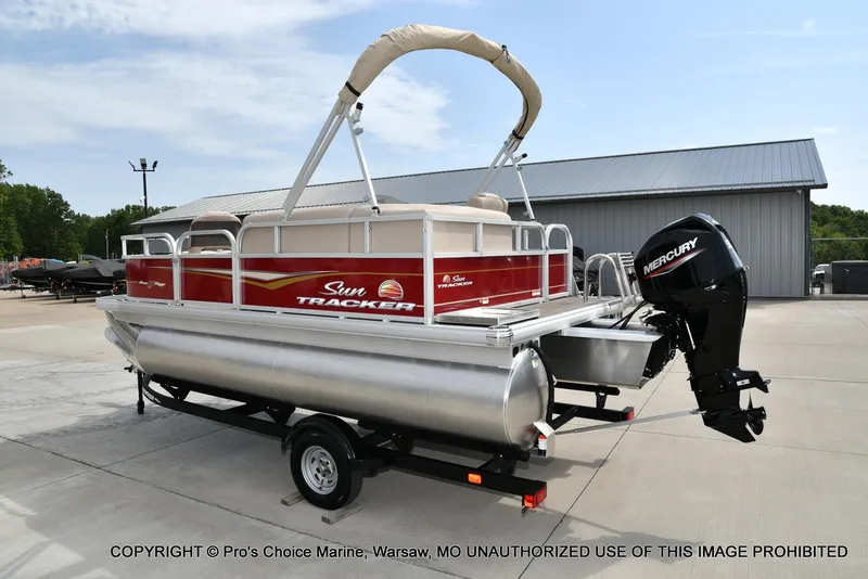 Slide: The Image of 2025 Sun Tracker Bass Buggy 16 DLX pontoon boat with 50HP Mercury engine on trailer. - 13