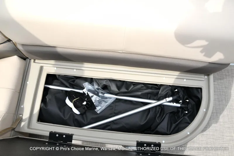 Slide: The Image of Storage compartment in 2025 Sun Tracker Bass Buggy 16 DLX boat, containing poles and accessories. - 37