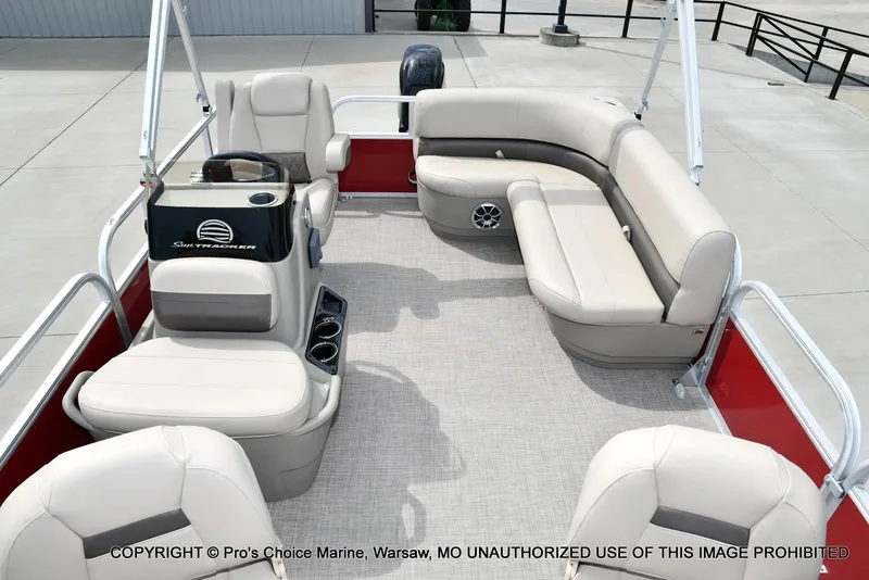 Slide: The Image of 2025 Sun Tracker Bass Buggy 16 DLX interior with beige seating and steering console. - 4