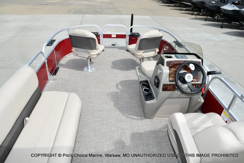 Slide: The Image of 2025 Sun Tracker Bass Buggy 16 DLX pontoon boat interior with seating and steering console. - 42