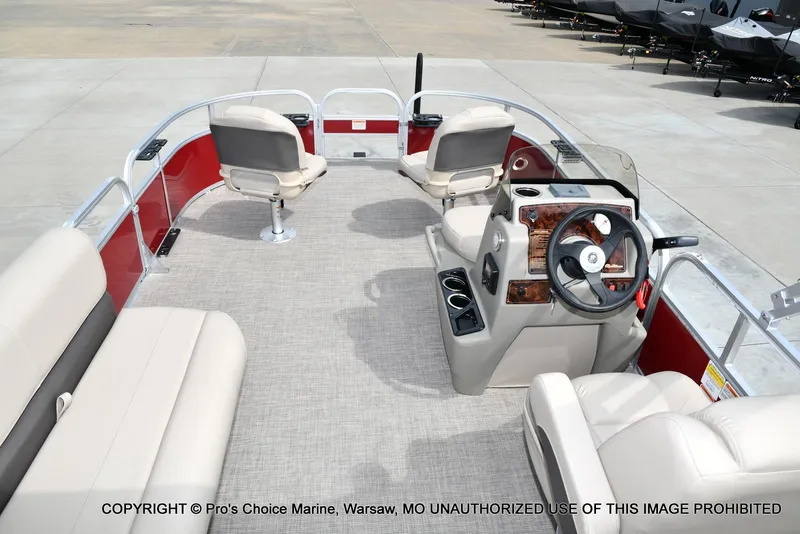 Slide: The Image of 2025 Sun Tracker Bass Buggy 16 DLX pontoon boat interior with steering console and seating. - 43