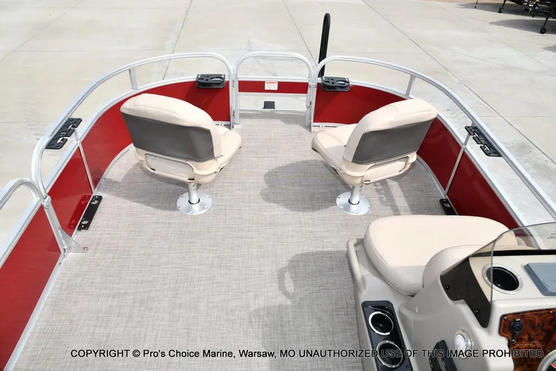 Slide: The Image of 2025 Sun Tracker Bass Buggy 16 DLX pontoon boat interior with beige seating and red panels. - 44