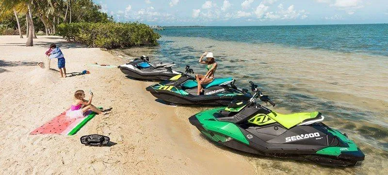 Slide: The Image of 2019 Sea-Doo Spark Trixx 2up iBR jet skis on a sunny beach. - 12