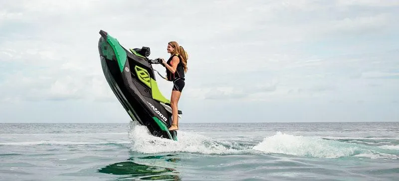 Slide: The Image of 2019 Sea-Doo Spark Trixx 2up performing a wheelie on open water. - 8