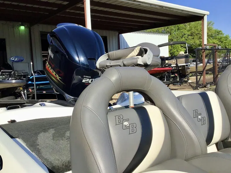Slide: The Image of 2018 Bass Cat Panterra II boat with Yamaha 200 engine, parked under a metal canopy. - 15
