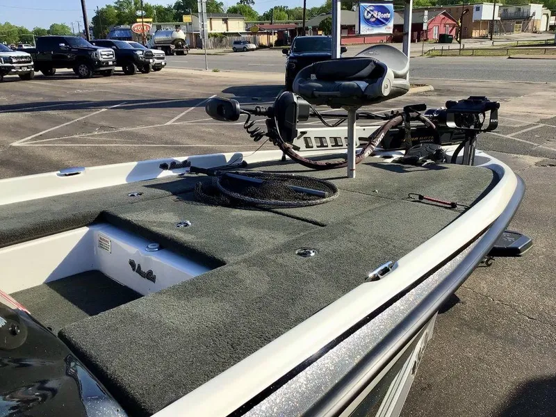 Slide: The Image of 2018 Bass Cat Panterra II boat with fishing equipment, parked in a lot. - 21