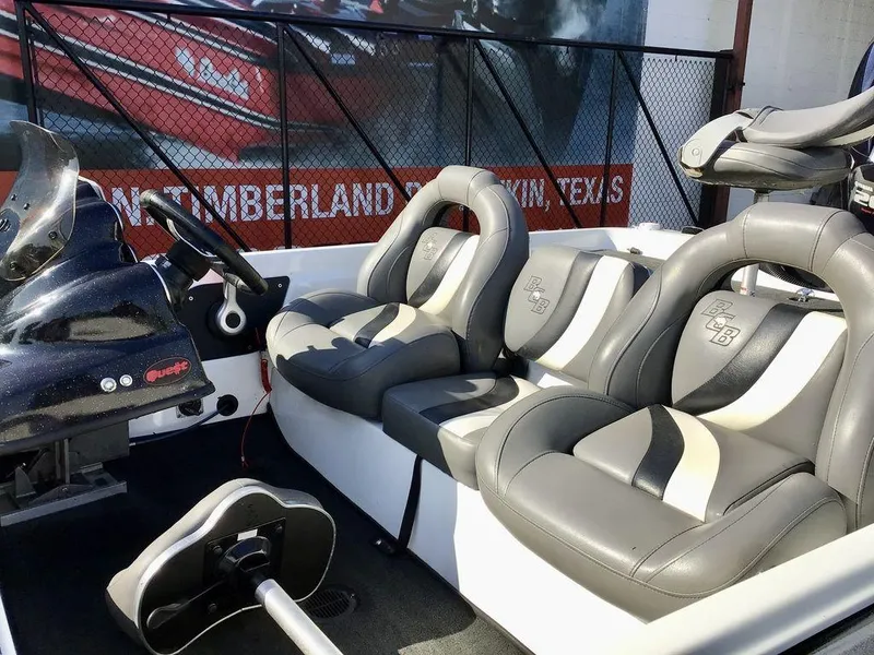 Slide: The Image of 2018 Bass Cat Panterra II boat interior with gray and white seating. - 29
