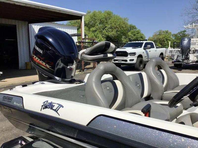 Slide: The Image of 2018 Bass Cat Panterra II boat with Yamaha 200 engine, parked near a white truck. - 38