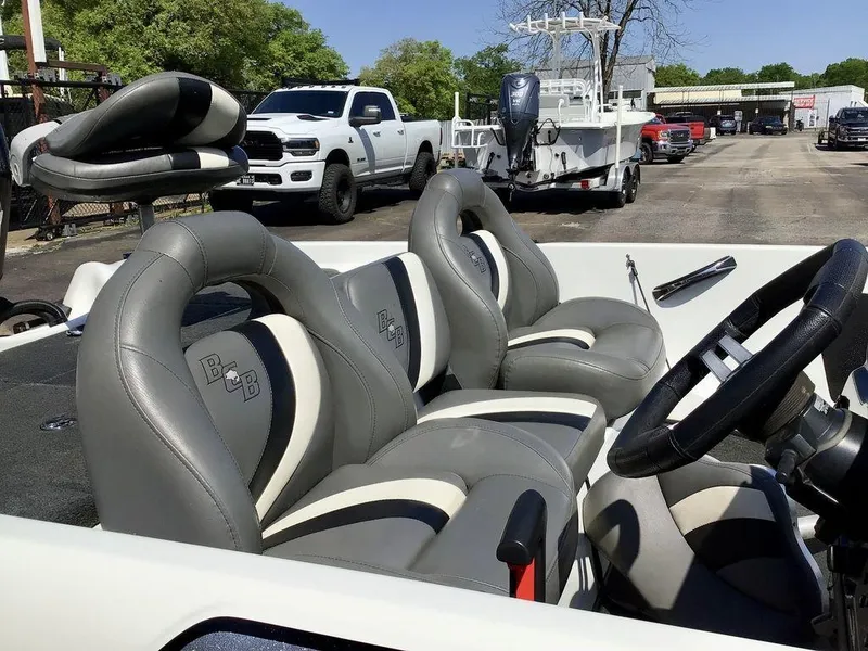 Slide: The Image of 2018 Bass Cat Panterra II boat interior with gray leather seats and steering wheel. - 39