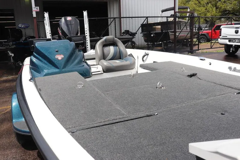 Slide: The Image of 2021 Bass Cat Pantera II boat with spacious deck and seating, parked outdoors. - 18