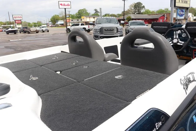 Slide: The Image of 2021 Bass Cat Pantera II boat interior with gray seating and storage compartments. - 22