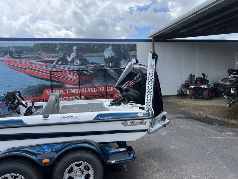 Slide: The Image of 2021 Bass Cat Pantera II boat with Mercury Pro XS engine, parked near a motorsports shop. - 32