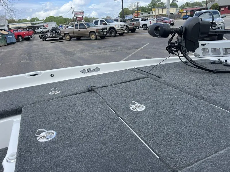 Slide: The Image of 2021 Bass Cat Pantera II boat deck with storage compartments in a parking lot. - 47