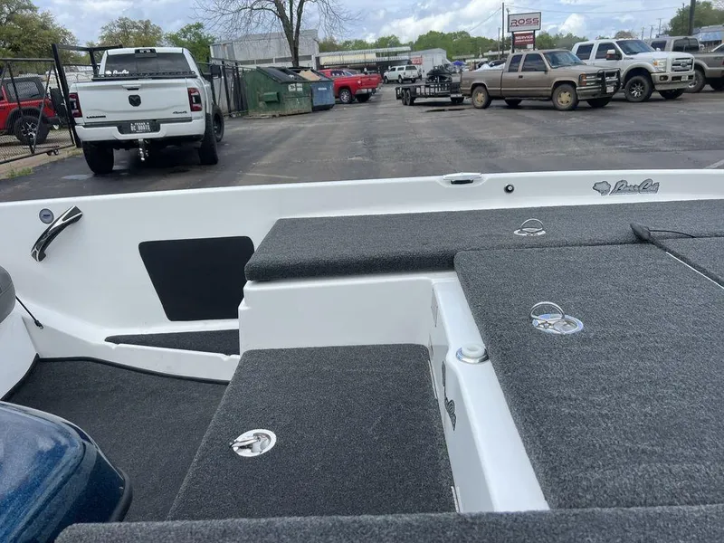 Slide: The Image of 2021 Bass Cat Pantera II boat interior with gray carpet, parked in a lot. - 48
