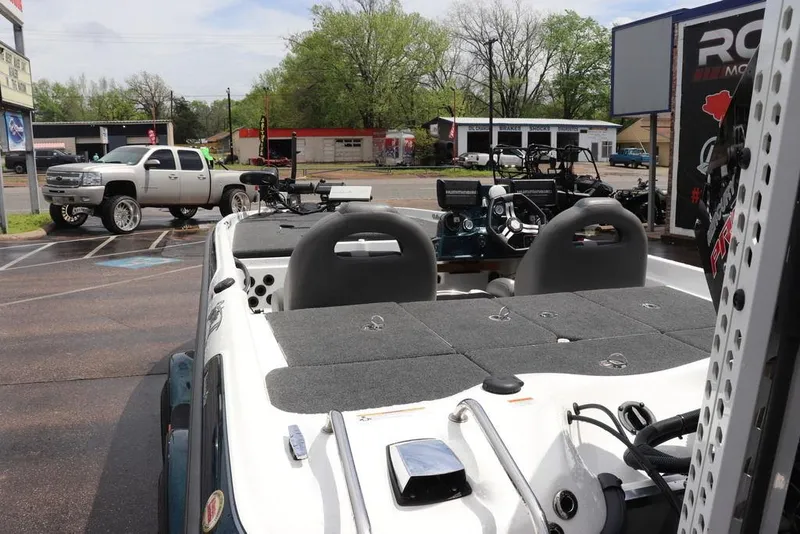 Slide: The Image of 2021 Bass Cat Pantera II boat parked, featuring dual seats and advanced fishing equipment. - 6