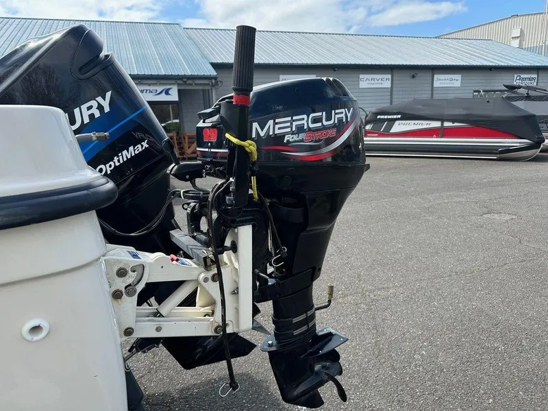 Slide: The Image of Mercury outboard motor on a Trophy 2002 boat, parked near a marina. - 13