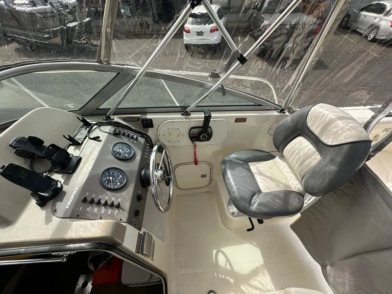 Slide: The Image of Interior of a 2002 Trophy boat showing steering wheel, gauges, and captain's chair. - 2