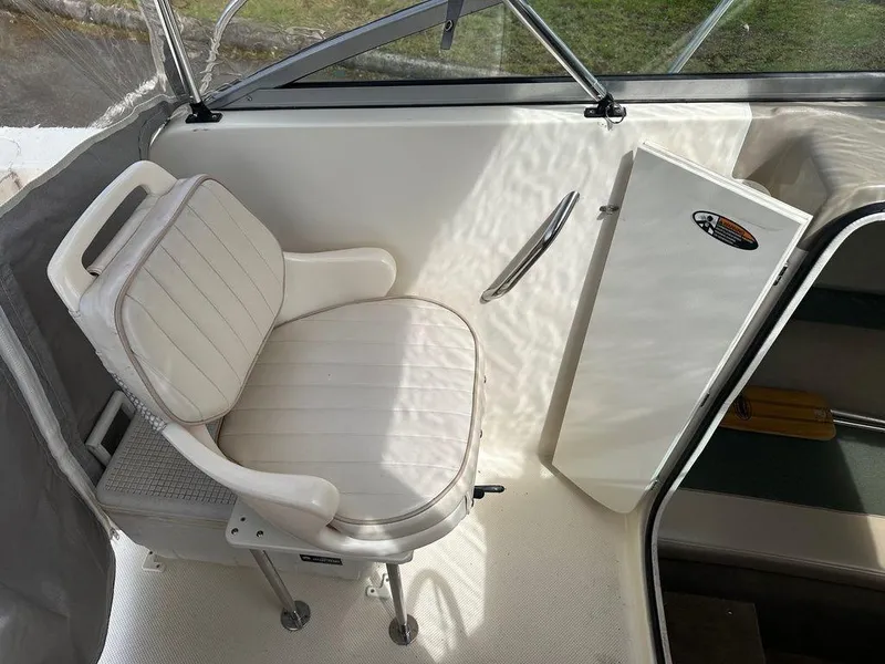 Slide: The Image of White seat in a 2002 Trophy boat interior, near a storage compartment. - 3