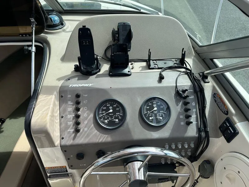 Slide: The Image of Dashboard of a 2002 Trophy boat with gauges and controls. - 4