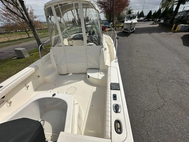 Slide: The Image of 2002 Trophy boat with covered cockpit, parked on a paved road. - 6