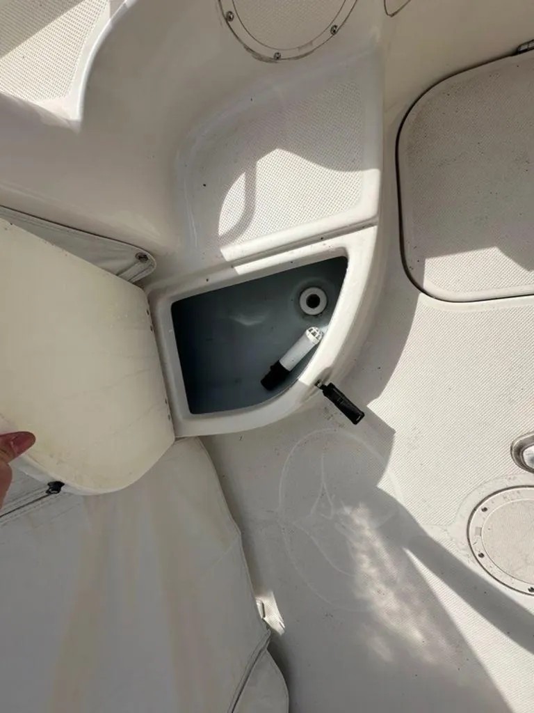 Slide: The Image of Open storage compartment on a 2002 Trophy boat deck, showing interior details. - 7