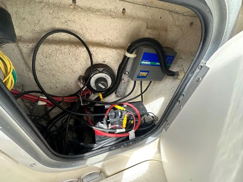 Slide: The Image of Electrical compartment of a 2002 Trophy boat with wiring and battery charger. - 8