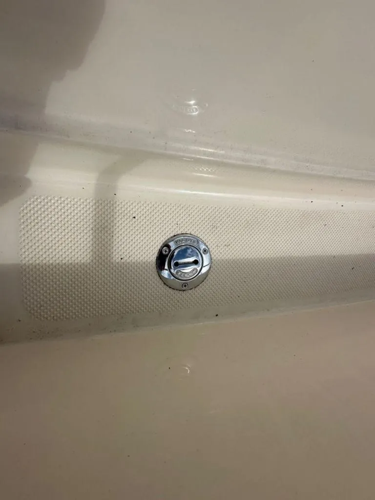 Slide: The Image of Fuel cap on a 2002 Trophy boat deck, featuring textured surface. - 9