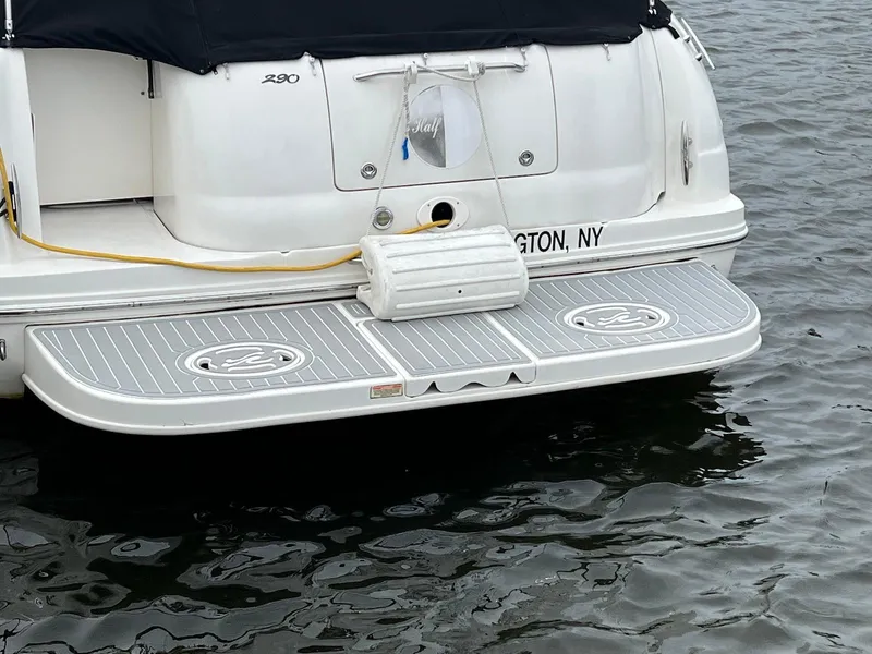 Slide: The Image of 2005 Sea Ray 290 Amberjack boat stern with swim platform on water. - 3