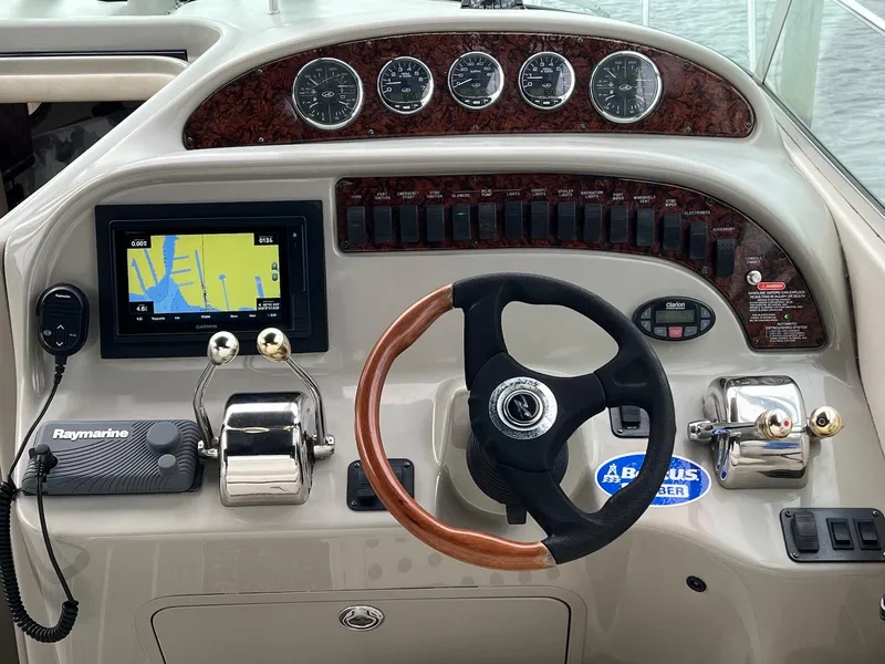 Slide: The Image of 2005 Sea Ray 290 Amberjack dashboard with steering wheel, gauges, and navigation system. - 4