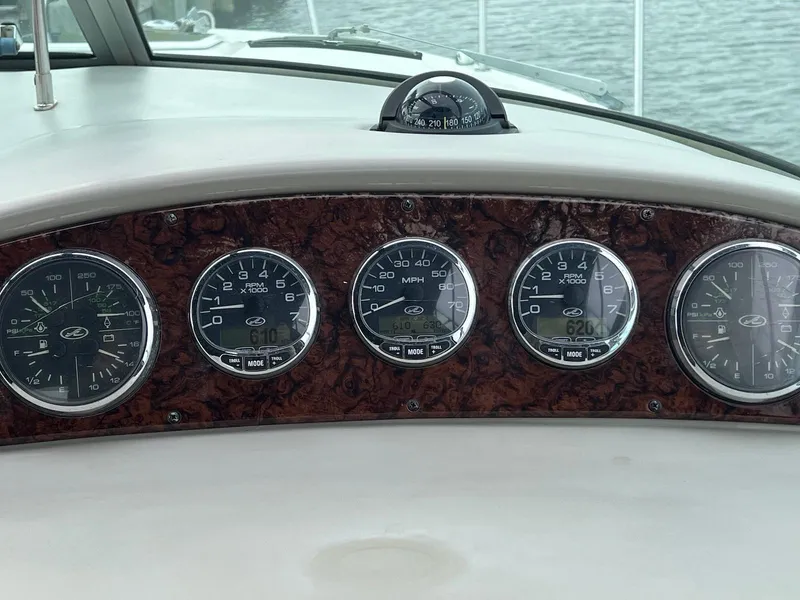 Slide: The Image of Dashboard of a 2005 Sea Ray 290 Amberjack boat with gauges and compass. - 5