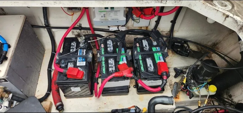 Slide: The Image of Battery compartment of a 2005 Sea Ray 290 Amberjack with multiple batteries and wiring. - 8