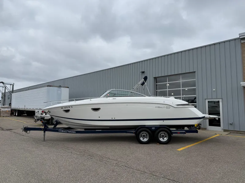 Slide: The Image of 2013 Cobalt 273 boat on trailer outside industrial building. - 1