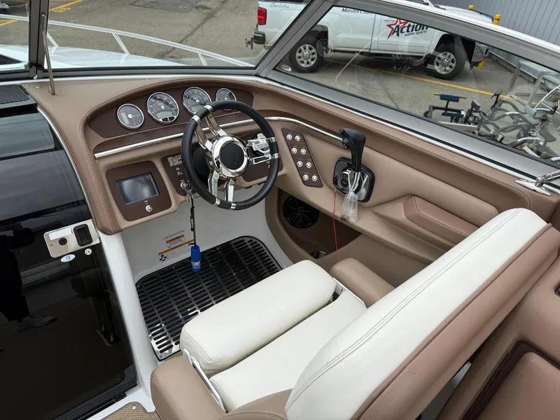 Slide: The Image of Interior of a 2013 Cobalt 273 boat, featuring steering wheel and control panel. - 10