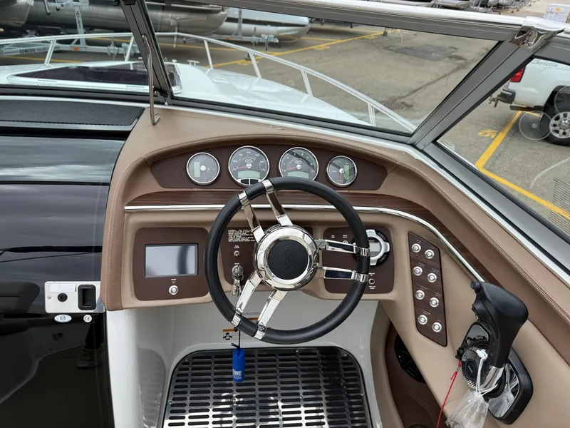 Slide: The Image of 2013 Cobalt 273 boat dashboard with steering wheel and control panel. - 11