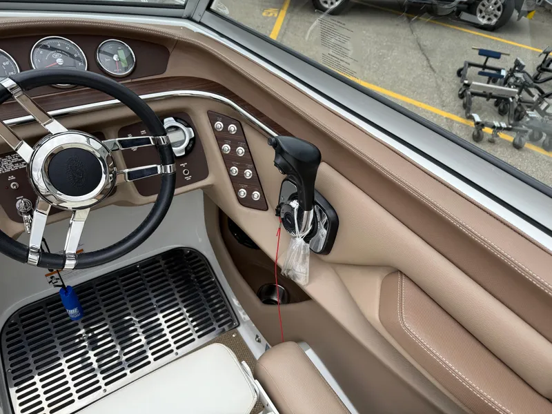 Slide: The Image of Interior of a 2013 Cobalt 273 boat, featuring steering wheel and control panel. - 12