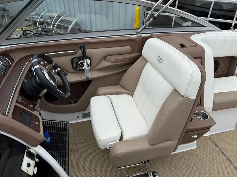 Slide: The Image of Interior of a 2013 Cobalt 273 boat with beige and white seating. - 13