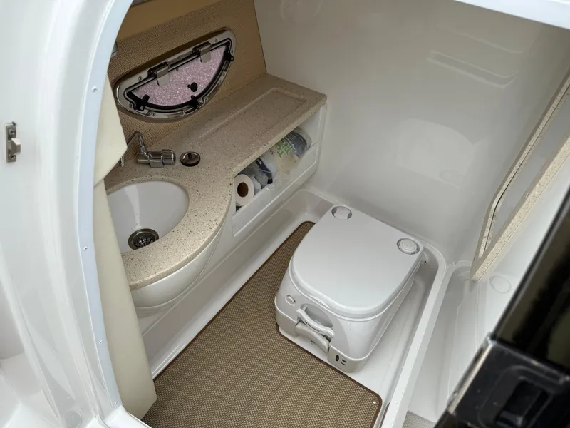 Slide: The Image of Compact bathroom in 2013 Cobalt 273 boat with sink, toilet, and storage. - 17
