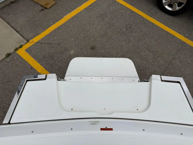 Slide: The Image of Rear view of a 2013 Cobalt 273 boat on pavement with yellow parking lines. - 23
