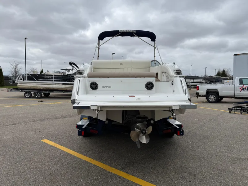 Slide: The Image of 2013 Cobalt 273 boat on trailer in parking lot, overcast sky. - 4