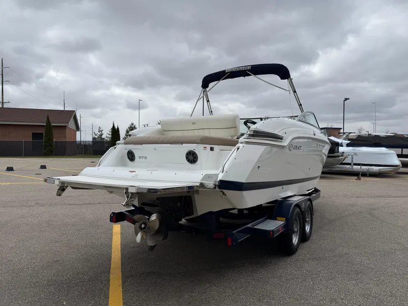 Slide: The Image of 2013 Cobalt 273 boat on trailer in parking lot under cloudy sky. - 5
