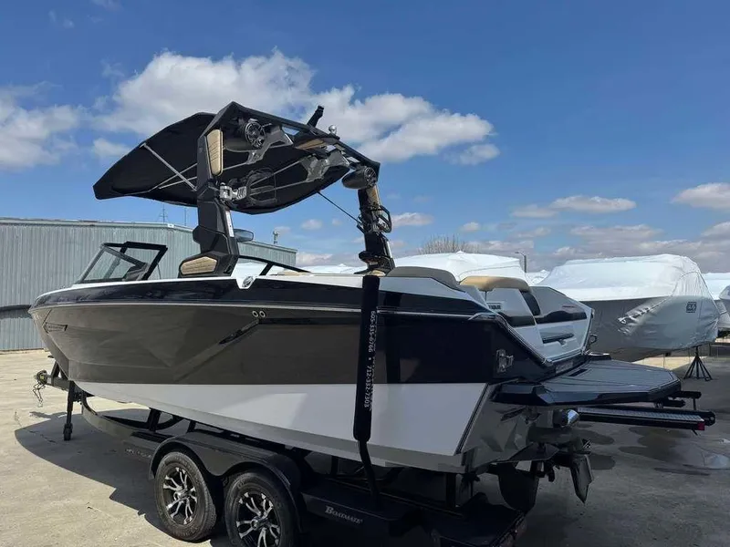 Slide: The Image of 2022 Nautique Super Air Nautique G21 boat on trailer under blue sky. - 1