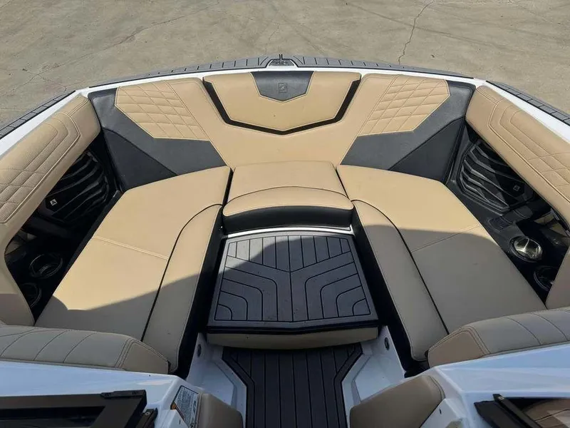Slide: The Image of 2022 Nautique Super Air Nautique G21 boat interior with beige and black seating. - 4