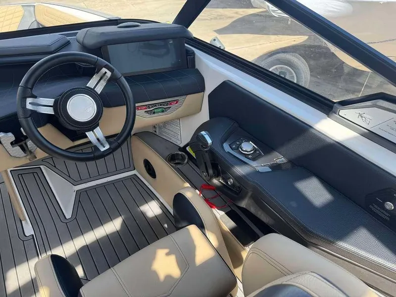 Slide: The Image of Interior of 2022 Nautique Super Air Nautique G21 boat, featuring steering wheel and dashboard controls. - 6