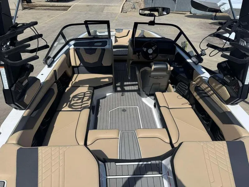 Slide: The Image of 2022 Nautique Super Air Nautique G21 interior with tan seating and sleek design. - 7