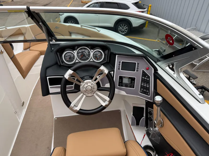 Slide: The Image of 2018 MasterCraft XT23 boat dashboard with steering wheel and control panel. - 11