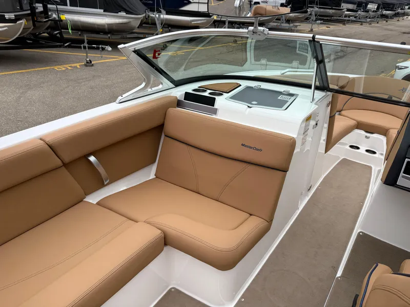 Slide: The Image of 2018 MasterCraft XT23 boat interior with tan seating and sleek design. - 13